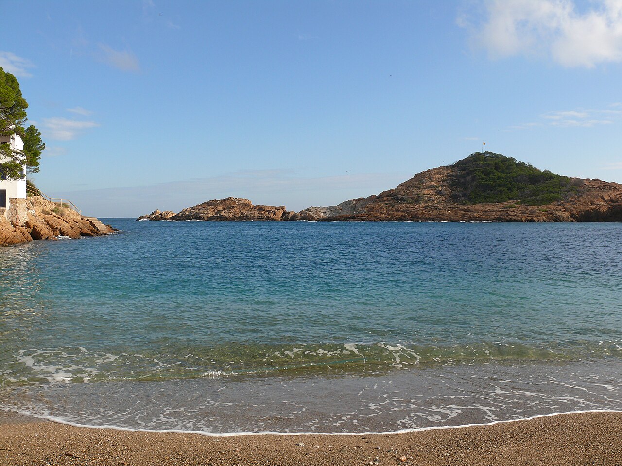 Cala Sa Tuna in Begur, a small pebble cove lined with whitewashed fishermen's houses