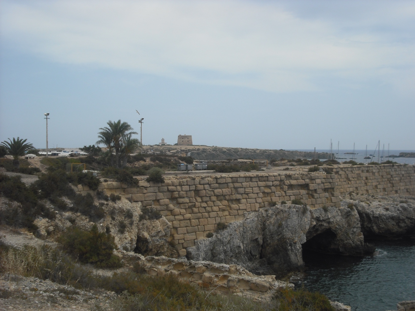 The rocky coast and walls of Isla de Tabarca near the Cova del Llop Marí, Alicante