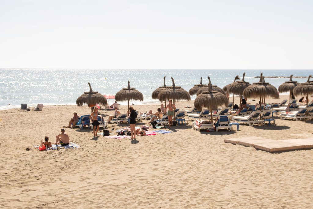 Travel insurance for Spain: a busy Spanish beach in summer